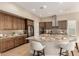 Modern kitchen featuring a spacious island, stainless steel appliances, and custom wood cabinets at 16639 W Pinchot Ave, Goodyear, AZ 85395