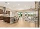 Open-concept living room with a kitchen island, hardwood floors, a white couch, and natural light at 16639 W Pinchot Ave, Goodyear, AZ 85395