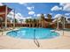 Beautiful community pool area with plenty of seating and shade canopies, creating a resort-like atmosphere at 16639 W Pinchot Ave, Goodyear, AZ 85395