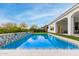 Backyard swimming pool featuring stone accents, tile detailing and pristine landscaping at 16639 W Pinchot Ave, Goodyear, AZ 85395