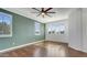 Bedroom with dark wood floors, green accent wall, and plantation shutters at 1811 E Powell Way, Chandler, AZ 85249