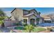 Two-story house with landscaped yard, two-car garage, and a welcoming front porch at 1811 E Powell Way, Chandler, AZ 85249