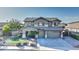 Two-story house with landscaped yard, two-car garage, and a welcoming front porch at 1811 E Powell Way, Chandler, AZ 85249