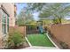 Landscaped backyard with artificial turf, playset and a slide at 18140 N 92Nd St, Scottsdale, AZ 85255