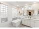 Elegant bathroom with double vanity, soaking tub, and glass block windows at 18140 N 92Nd St, Scottsdale, AZ 85255