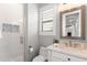 Modern bathroom with a walk-in shower, toilet and a vanity with a quartz countertop at 18140 N 92Nd St, Scottsdale, AZ 85255