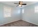 Light blue bedroom with gray carpeting and two windows with plantation shutters at 18140 N 92Nd St, Scottsdale, AZ 85255