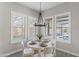 Bright breakfast nook with a round table and white chairs at 18140 N 92Nd St, Scottsdale, AZ 85255