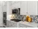 Elegant kitchen with white cabinets and designer backsplash at 18140 N 92Nd St, Scottsdale, AZ 85255