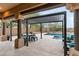 Covered patio with pergola, outdoor seating, and pool view at 18140 N 92Nd St, Scottsdale, AZ 85255