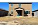 Backyard view of a two-story home featuring a covered patio and xeriscaping at 18225 W Yavapai St, Goodyear, AZ 85338