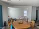 Dining area with wooden table and chairs, view into Gathering room at 18225 W Yavapai St, Goodyear, AZ 85338