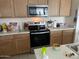 Bright kitchen with stainless steel appliances and light wood cabinets at 18225 W Yavapai St, Goodyear, AZ 85338