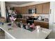 Kitchen with island, stainless steel appliances, and light wood cabinets at 18225 W Yavapai St, Goodyear, AZ 85338