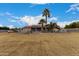 Large grassy backyard with a view of the house at 18509 W Bethany Home Rd, Litchfield Park, AZ 85340