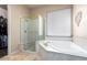 Bathroom with a large soaking tub, walk-in shower, and double vanity at 18509 W Bethany Home Rd, Litchfield Park, AZ 85340