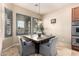 Cozy breakfast nook with a square table and gray chairs at 18509 W Bethany Home Rd, Litchfield Park, AZ 85340