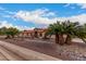 House exterior with desert landscaping and palm trees at 18509 W Bethany Home Rd, Litchfield Park, AZ 85340