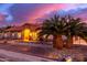 Gorgeous ranch house exterior at sunset, with palm trees and stone landscaping at 18509 W Bethany Home Rd, Litchfield Park, AZ 85340