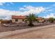 Single-story home with a tile roof, stone accents and palm trees at 18509 W Bethany Home Rd, Litchfield Park, AZ 85340