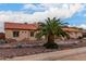 Single-story home with a tile roof, stone accents and palm trees at 18509 W Bethany Home Rd, Litchfield Park, AZ 85340