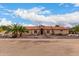 Single-story home with a tile roof, stone accents and palm trees at 18509 W Bethany Home Rd, Litchfield Park, AZ 85340