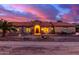 Stunning ranch house exterior at sunset, featuring a tile roof and stone accents at 18509 W Bethany Home Rd, Litchfield Park, AZ 85340