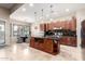 Island kitchen with dark wood cabinets and granite counters at 18509 W Bethany Home Rd, Litchfield Park, AZ 85340