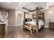 Main bedroom with a large four-poster bed and ensuite bathroom access at 18509 W Bethany Home Rd, Litchfield Park, AZ 85340