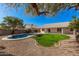 Landscaped backyard with a sparkling pool and grassy area at 19045 N 47Th Cir, Glendale, AZ 85308