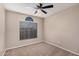 Well-lit bedroom with ceiling fan and arched window at 19045 N 47Th Cir, Glendale, AZ 85308