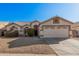 One-story house with beige exterior, two-car garage, and landscaped front yard at 19045 N 47Th Cir, Glendale, AZ 85308