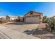 One-story house with beige exterior, two-car garage, and landscaped front yard at 19045 N 47Th Cir, Glendale, AZ 85308