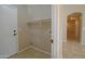 Well-lit laundry room with built-in shelving and tile floor at 19045 N 47Th Cir, Glendale, AZ 85308