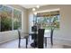 Bright dining area with glass table and chairs, overlooking backyard at 2005 N 169Th Ave, Goodyear, AZ 85395