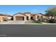 Tan single story house with brown garage door and walkway at 2005 N 169Th Ave, Goodyear, AZ 85395