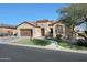 Single-story house with solar panels, a brown garage door, and a landscaped yard at 2005 N 169Th Ave, Goodyear, AZ 85395