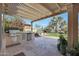 Outdoor kitchen with grill, sink and countertop under covered pergola at 2005 N 169Th Ave, Goodyear, AZ 85395