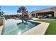 Backyard pool with travertine tile and artificial grass, perfect for outdoor relaxation at 2005 N 169Th Ave, Goodyear, AZ 85395