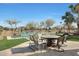 Pool area with seating, fire pit table and view of the golf course at 2005 N 169Th Ave, Goodyear, AZ 85395