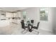 Bright dining area with glass table and four chairs, near kitchen at 21743 N Daniel Dr, Maricopa, AZ 85138