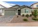 New construction home with a two-car garage and landscaped front yard at 21743 N Daniel Dr, Maricopa, AZ 85138