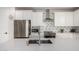 Modern kitchen with white cabinets, stainless steel appliances, and an island at 21743 N Daniel Dr, Maricopa, AZ 85138