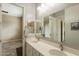 Double vanity bathroom with modern finishes and a large mirror at 22282 E Tierra Grande Ct, Queen Creek, AZ 85142