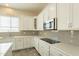 White kitchen cabinets, gray backsplash and modern appliances at 22282 E Tierra Grande Ct, Queen Creek, AZ 85142