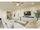 Bright and airy living room with a sectional sofa and access to kitchen at 22282 E Tierra Grande Ct, Queen Creek, AZ 85142