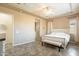 Bright bedroom with white platform bed and ceiling fan at 22282 E Tierra Grande Ct, Queen Creek, AZ 85142