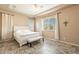 Spacious main bedroom with white platform bed and ensuite bathroom at 22282 E Tierra Grande Ct, Queen Creek, AZ 85142