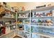 Well-organized pantry with plenty of storage shelves at 22282 E Tierra Grande Ct, Queen Creek, AZ 85142