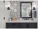 Bathroom with patterned tile, modern vanity, and large mirror at 2430 E Palo Verde Dr, Phoenix, AZ 85016